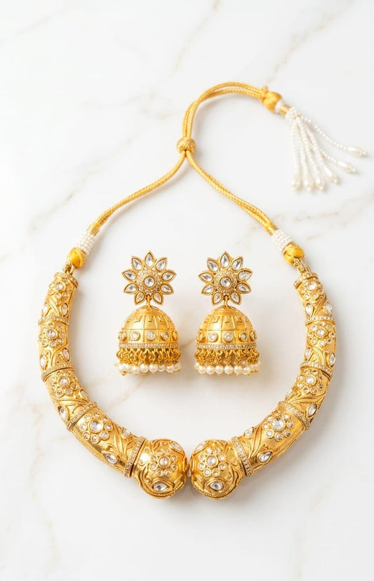 Rajmahal antique gold hasli necklace set with white kundan stones and matching jhumka earrings