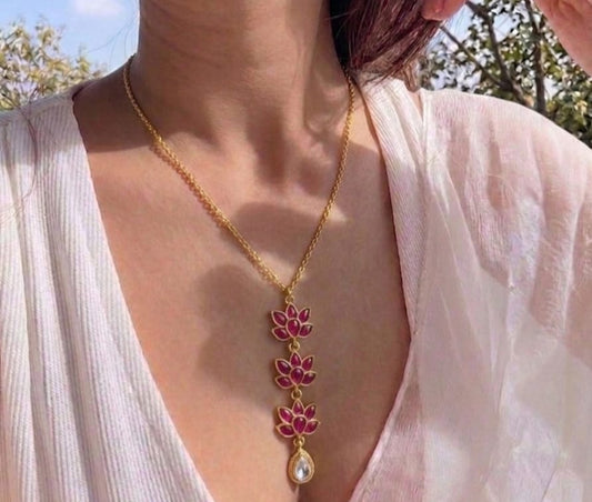 pendant necklace on gold chain worn