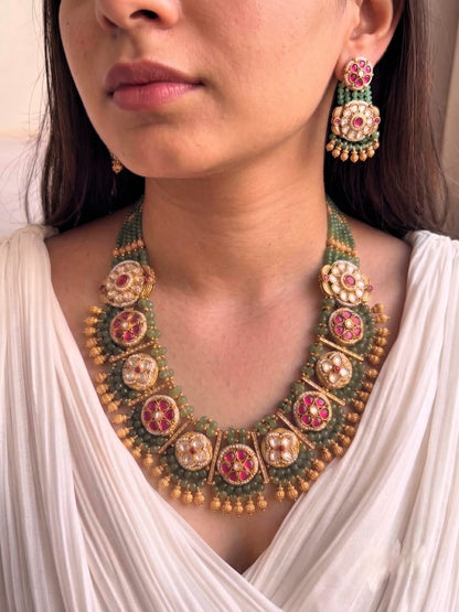 Kundan long necklace set with ruby stones and antique gold finish.