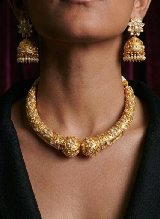 Rajmahal antique gold hasli necklace set with white kundan stones and matching jhumka earrings
